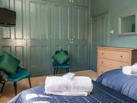 A bedroom with a bed and television at Blacksmith Mews in York