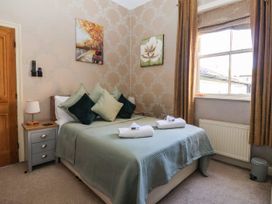 A bedroom with a bed and nightstand at Blacksmith Mews York