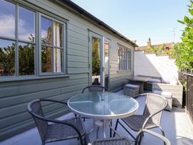 An outdoor seating area with a table and chairs at Blacksmith Mews in York