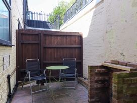 An outdoor area with chairs and a table at Blacksmith Mews in York