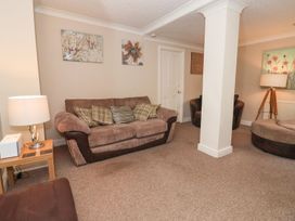 A living room with a sofa and armchairs at Blacksmiths Mews in York