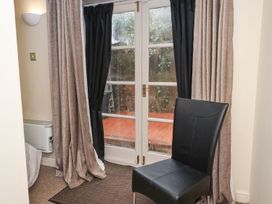 A seating area with a chair and curtains at Blacksmiths Mews in York