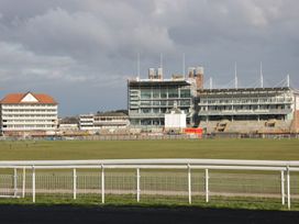 A racecourse with grandstands and a fence at Blacksmiths Mews, York