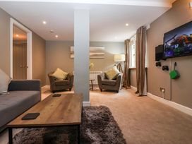 A living room with seating and a television at Blacksmiths Retreat in York