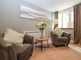 A living room with armchairs and a coffee table at Blacksmiths Retreat in York