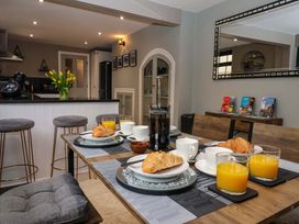A kitchen with a dining table set for breakfast at Blacksmiths Retreat in York