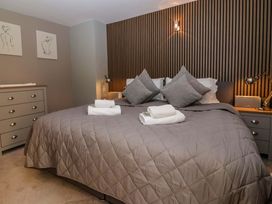 A bedroom with a double bed and decorative art at Blacksmiths Retreat in York