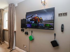 A living room with a television and gaming console at Blacksmiths Retreat in York