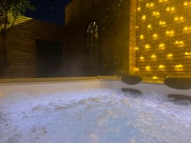A hot tub with water and fairy lights at Blacksmiths Retreat in York