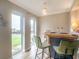 A bar area with stools and windows at Broadsands in Paignton