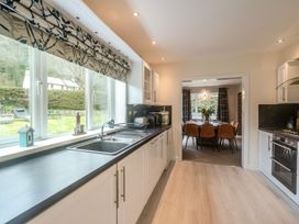 A kitchen with sink and cabinets at Broadsands in Paignton