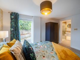 A bedroom with a bed and wardrobe at Broadsands in Paignton