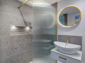 A bathroom with a shower and washbasin at Broadsands in Paignton