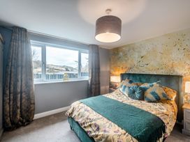 A bedroom with a bed and window at Broadsands in Paignton
