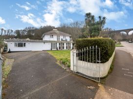 A house with a garage and driveway at Broadsands in Paignton
