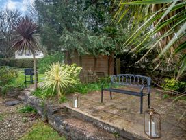 A garden with a bench and plants at Broadsands Paignton
