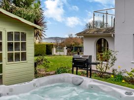 A garden with a hot tub and a shed at Broadsands in Paignton