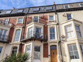 An exterior view of a townhouse with balconies and windows at Masons Place in Whitby