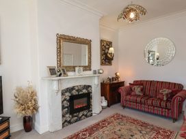 A living room with a fireplace and a sofa at Masons Place in Whitby