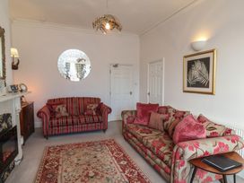 A living room with sofas and a fireplace at Masons Place in Whitby