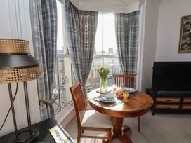 A dining area with a table and chairs at Masons Place in Whitby