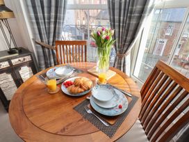 A dining room with a round table set for breakfast at Masons Place Whitby