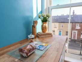 A kitchen countertop with cookies and a flower vase at Masons Place in Whitby