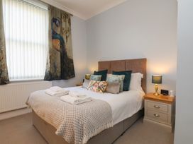 A bedroom with a bed and bedside tables at Masons Place in Whitby