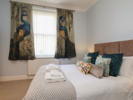 A bedroom with a bed and decorative pillows at Masons Place in Whitby