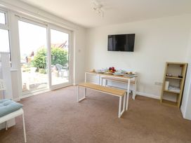 A dining room with a table and chairs at 32 Bowleaze Coveway in Weymouth