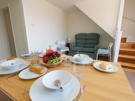 A dining room with a table set for a meal at 32 Bowleaze Coveway Weymouth
