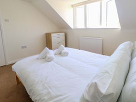 A bedroom with a bed and towels at 32 Bowleaze Coveway Weymouth