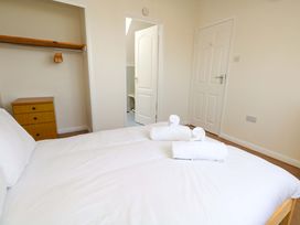 A bedroom with a bed and towels at 32 Bowleaze Coveway in Weymouth