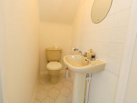A bathroom with a toilet and sink at 32 Bowleaze Coveway in Weymouth