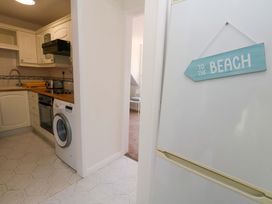 A kitchen with appliances and a sign at 32 Bowleaze Coveway Weymouth
