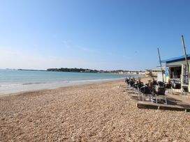 A beach with chairs and a cafe at 32 Bowleaze Coveway Weymouth