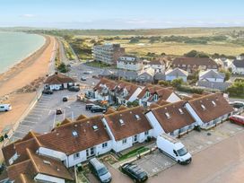 An outdoor view of houses and beach with a parking lot at 32 Bowleaze Coveway Preston