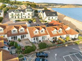 A view of buildings and beach at 32 Bowleaze Coveway in Preston
