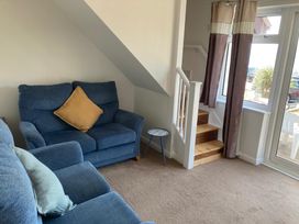 A living room with a sofa and stairs at Bella Rosa in Preston