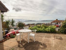 An outdoor area with a table and chairs overlooking the sea at Bella Rosa Preston