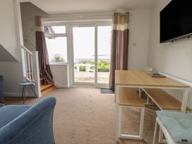 A living room with a dining table and staircase at Bella Rosa in Preston