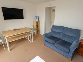 A living room with a sofa and dining table at Bella Rosa in Preston