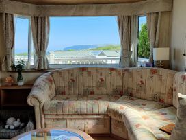 A living room with a sofa and table at Reighton Sands Holiday Park - Holiday Accommodation 17652 in Filey