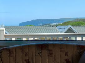 A living room with a view of rooftops and hills at Reighton Sands Holiday Park - Holiday Accommodation 17652, Filey