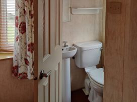 A bathroom with a toilet and sink at Reighton Sands Holiday Park - Holiday Accommodation 17652, Filey