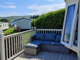 An outdoor seating area with a sofa at Reighton Sands Holiday Park - Holiday Accommodation 17652, Filey