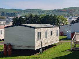 A static caravan with gas cylinders outside at Reighton Sands Holiday Park - Holiday Accommodation 17652 Filey