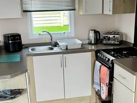 A kitchen with a sink and appliances at Static Caravan Hoburne Devon Bay in Paignton