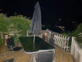 A table with umbrella and chairs in an outdoor area at House - Sleeps 7 - Garden - Pets Ok - Parking in Torquay