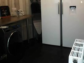 A laundry room with a washing machine and refrigerator at House - Sleeps 7 - Garden - Pets Ok - Parking in Torquay